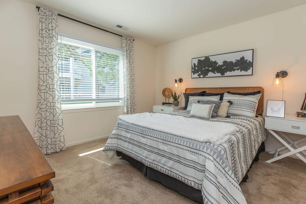 a bedroom with a bed and a window