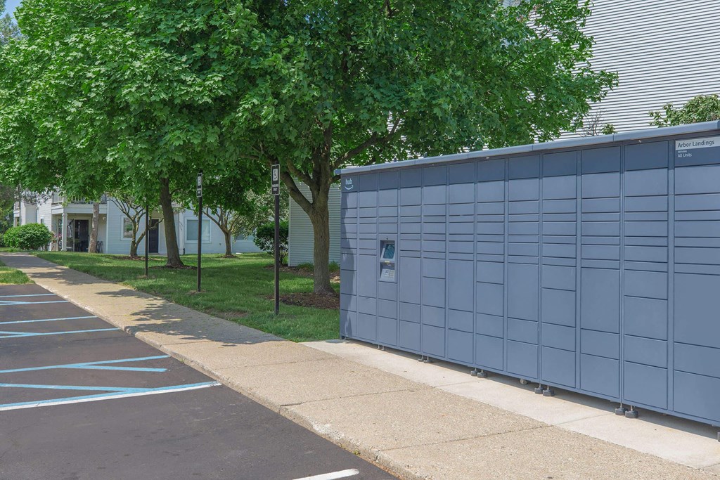 the side of a building in a parking lot with trees