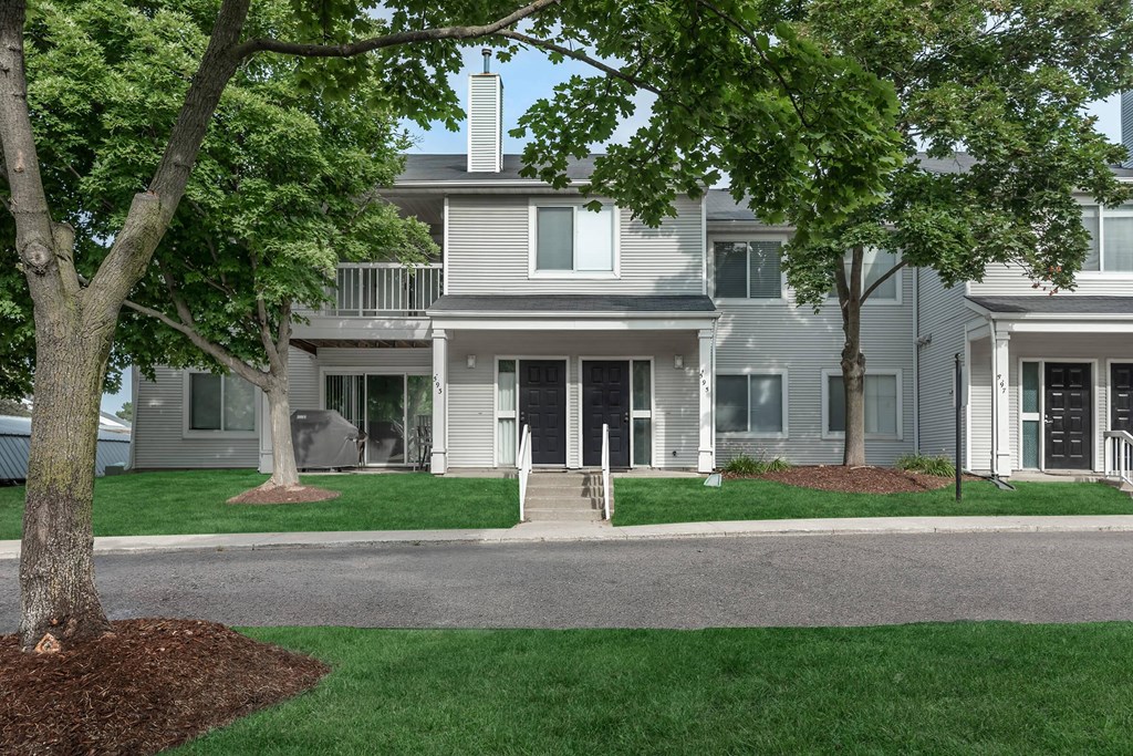 our apartments are located in a quiet neighborhood with green grass and trees