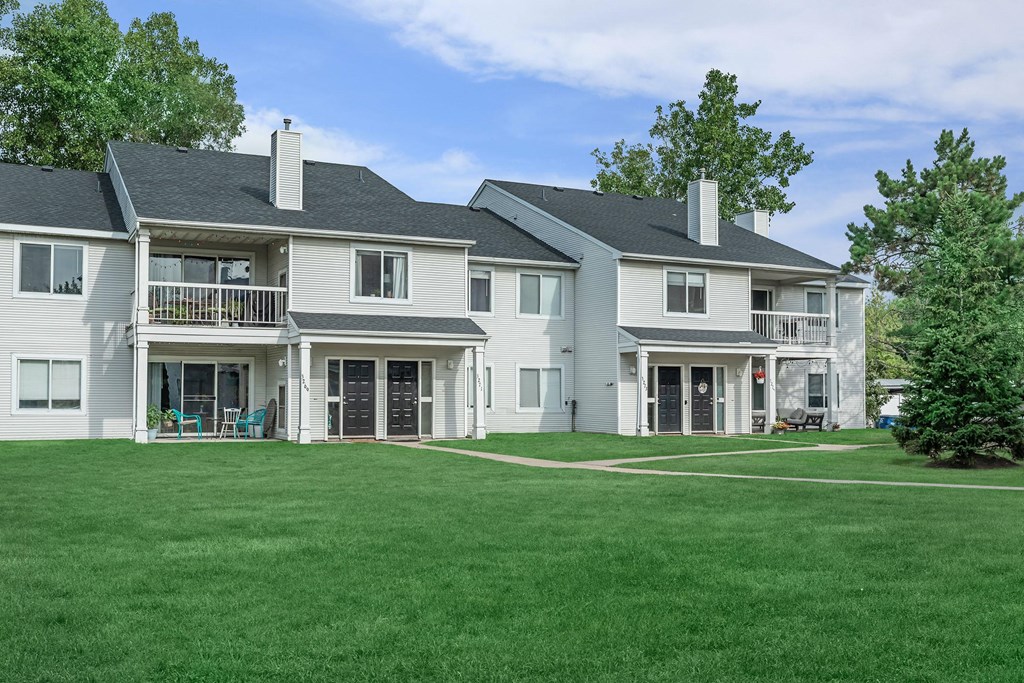 a large white house with a yard in front of it