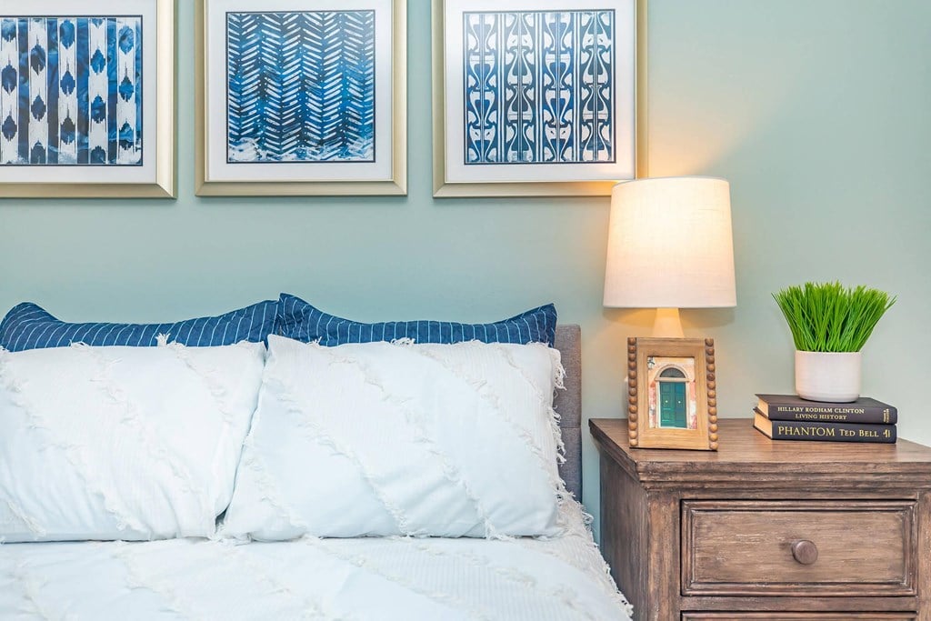 a bedroom with a bed and pictures on the wall