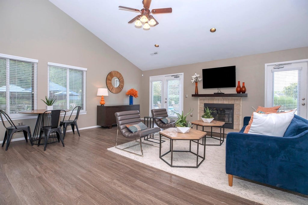 a living room with a blue couch and a table with chairs