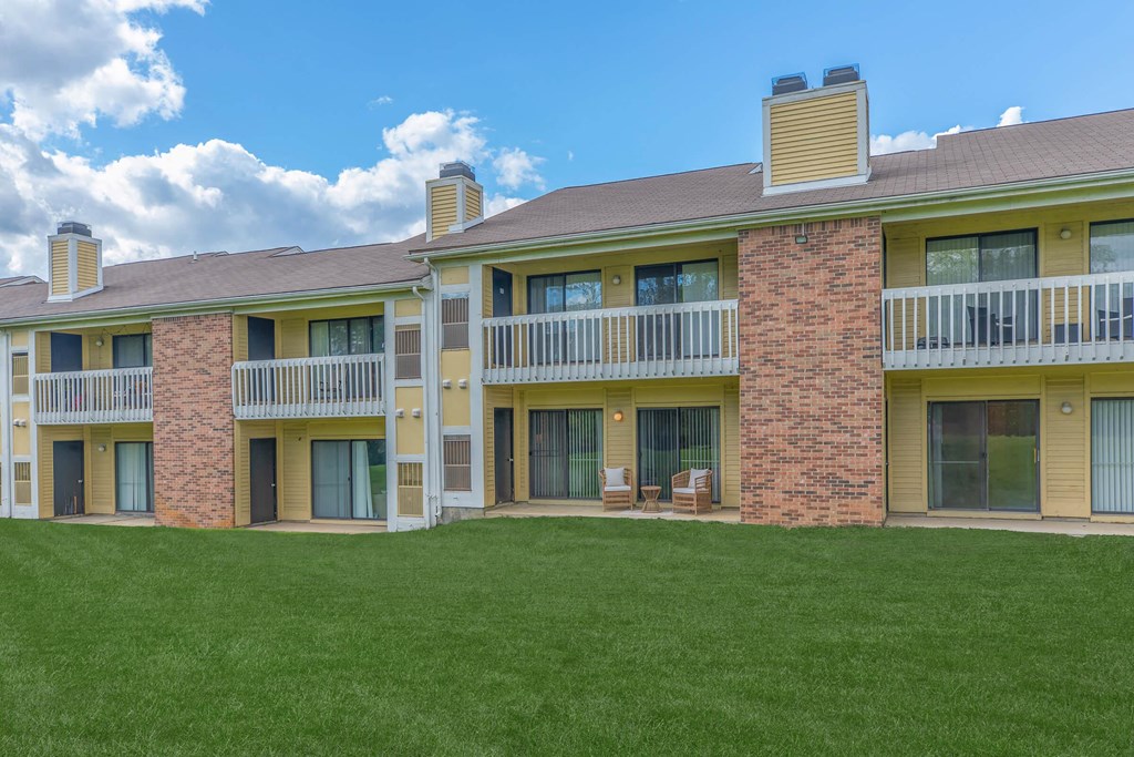 an exterior view of a building with green grass