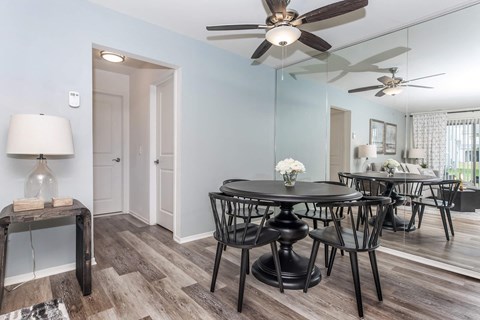 a dining room with a table and chairs