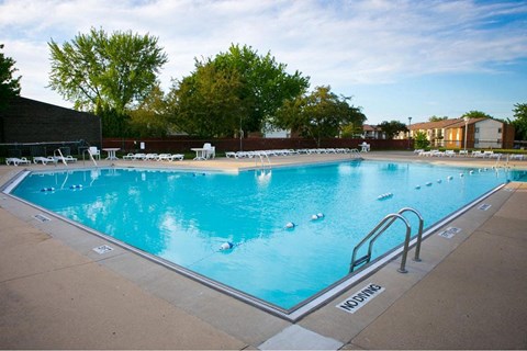 a swimming pool with chairs around it at a hotel