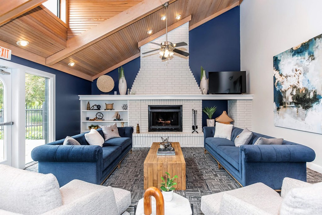 a living room with blue couches and a fireplace