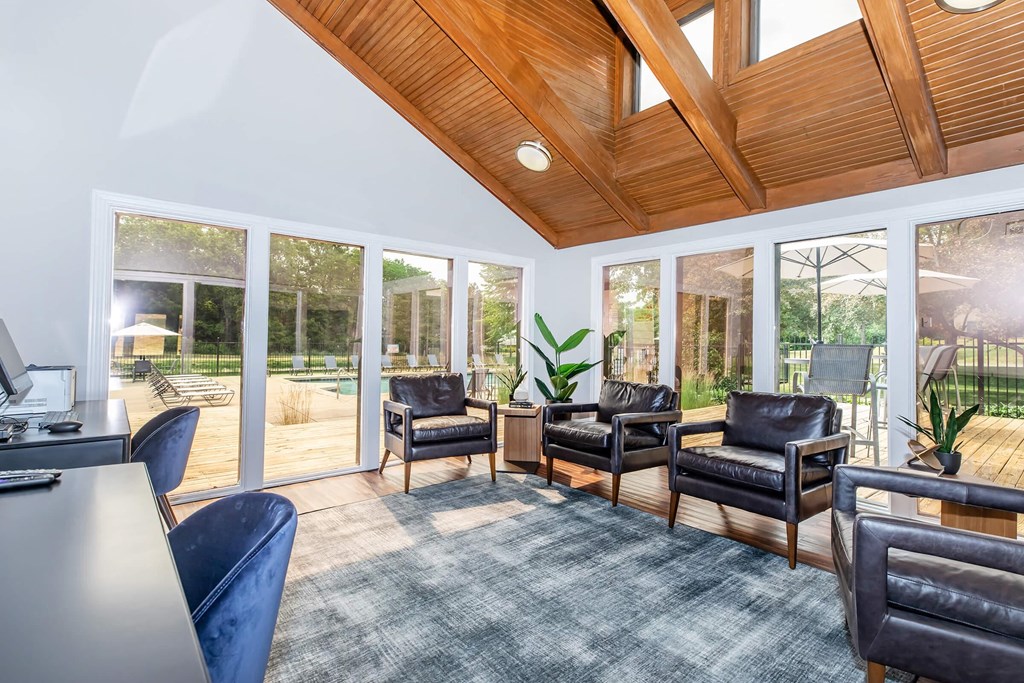 a living room with a couch and chairs and sliding glass doors