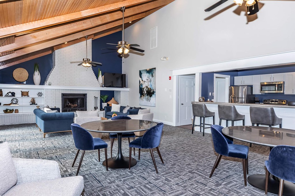 a living room with a table and chairs and a fireplace