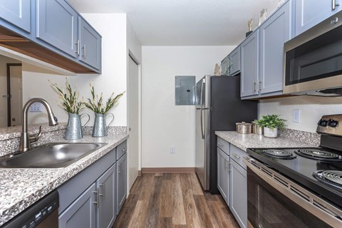 a kitchen with stainless steel appliances and granite counter tops