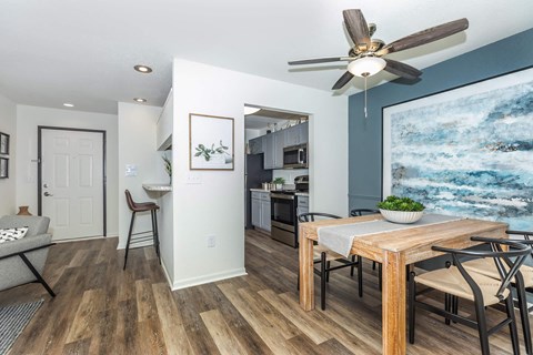 a dining room with a table and a ceiling fan