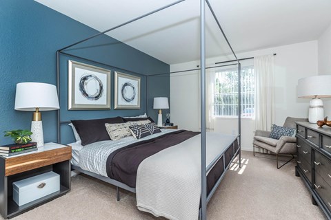 a bedroom with a large bed and a mirrored closet