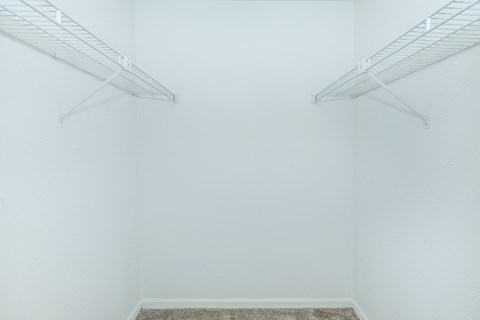 a room with white walls and two white racks on the wall