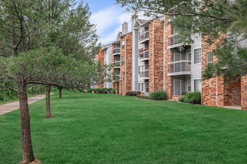 our apartments offer a spacious courtyard with green grass and trees