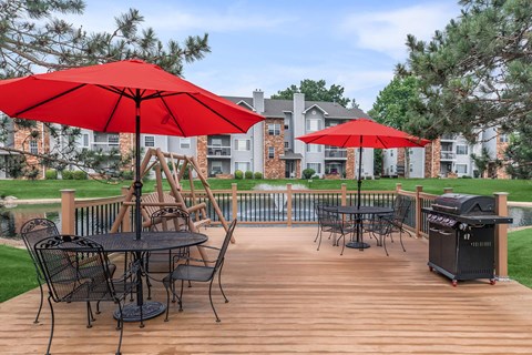 a patio with tables and chairs and umbrellas