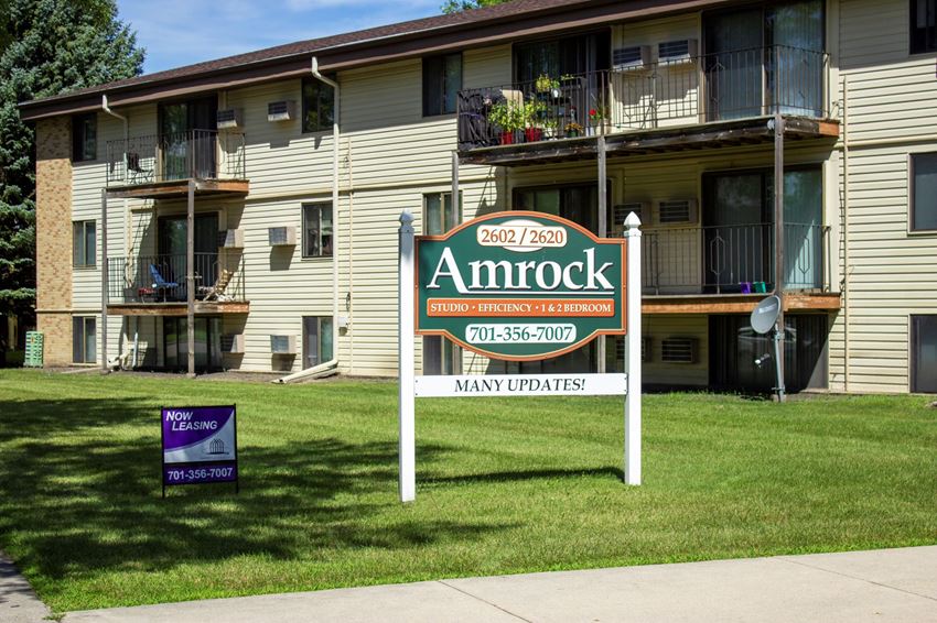 an amrock apartments sign in front of an apartment building