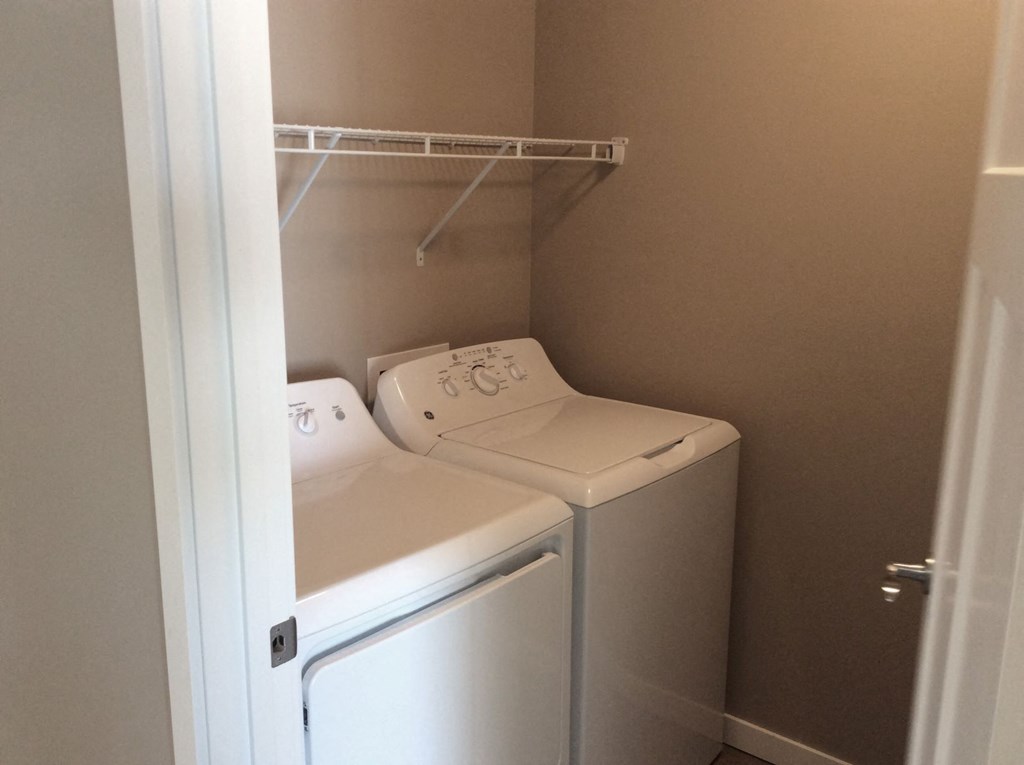 a small laundry room with a washer and dryer