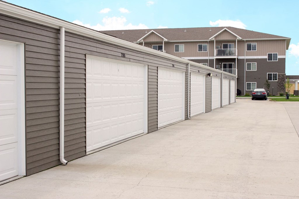 a row of garages in front of an apartment building