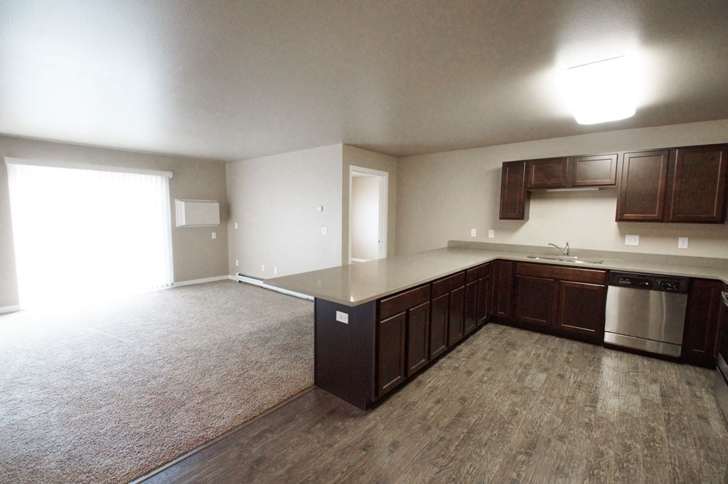 an empty kitchen and living room of an apartment