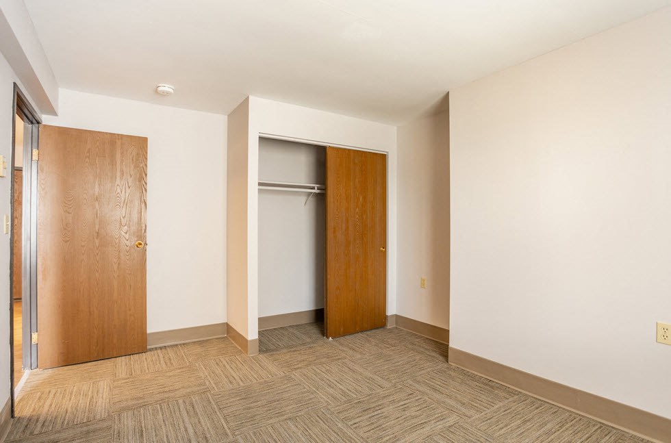 a empty room with a door to a closet