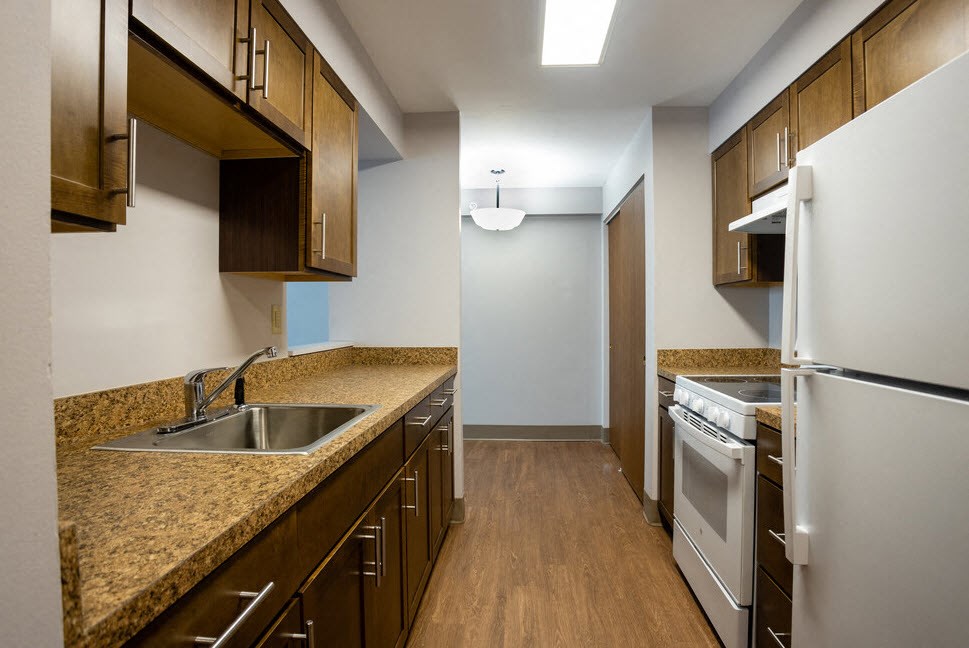 a kitchen with a sink and a refrigerator