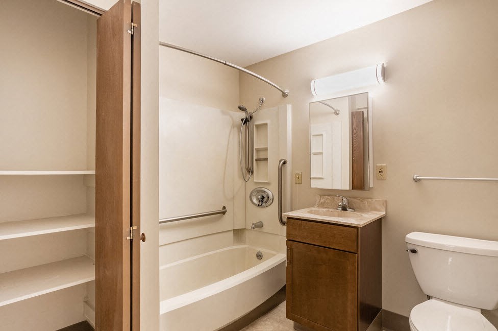 a bathroom with a toilet sink and a bath tub