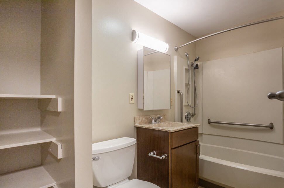 a bathroom with a toilet and a sink and a shower