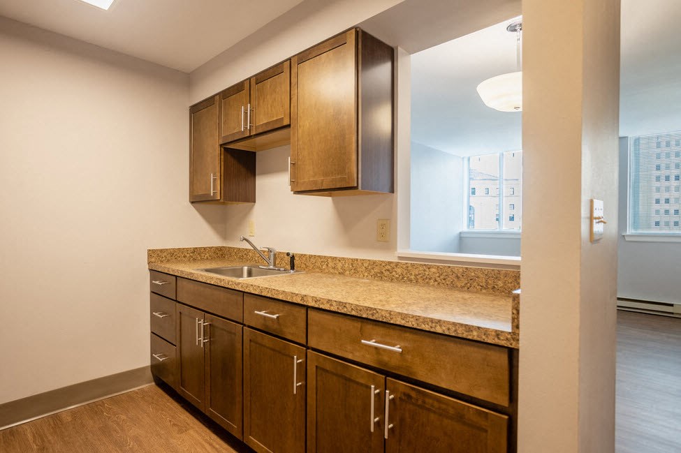a kitchen with wooden cabinets and a sink