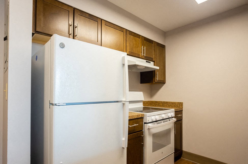 a kitchen with a white refrigerator and a stove