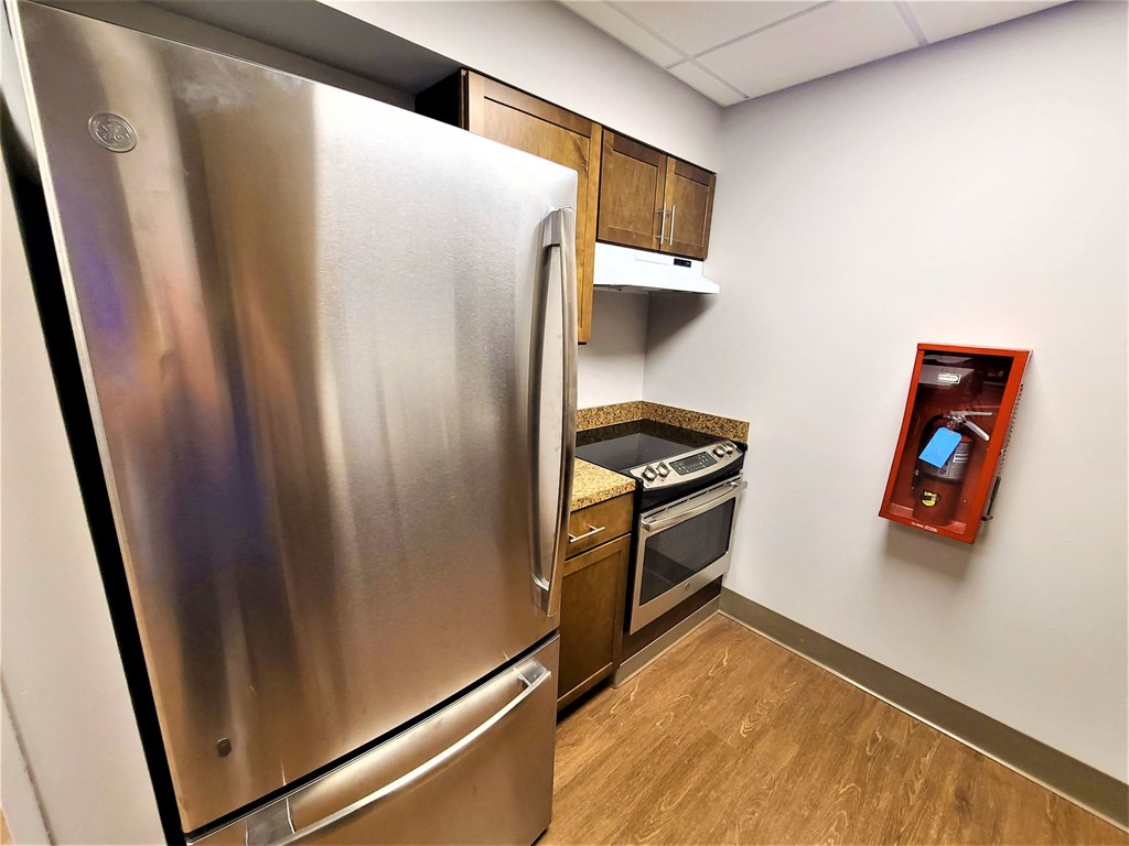 a kitchen with a stainless steel refrigerator and a stove