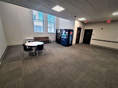 an empty room with a table and chairs in it