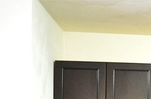 L-shaped kitchen with dark cabinets and gray countertop - Photo Gallery 4