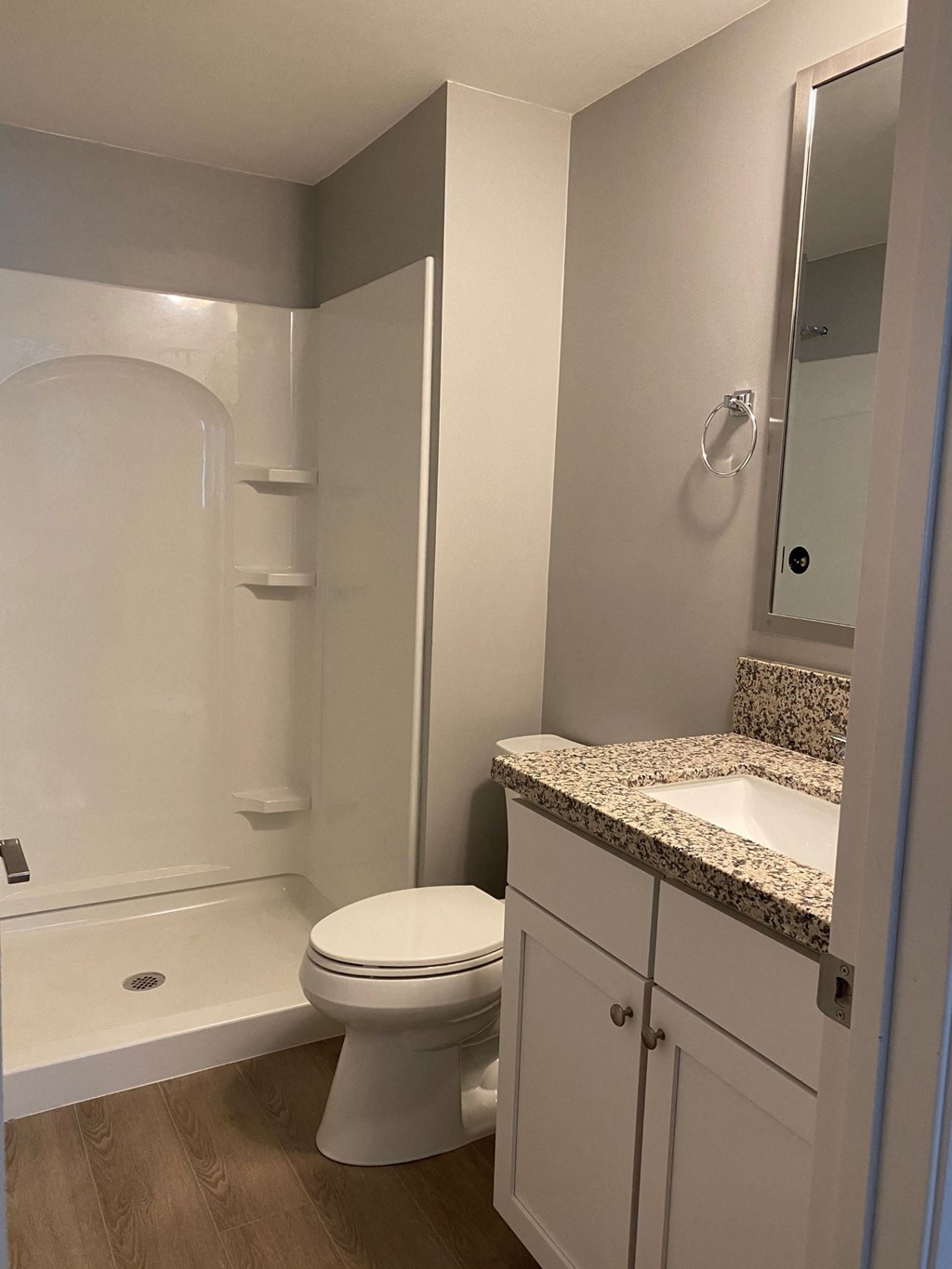 a bathroom with a toilet and a shower and a sink