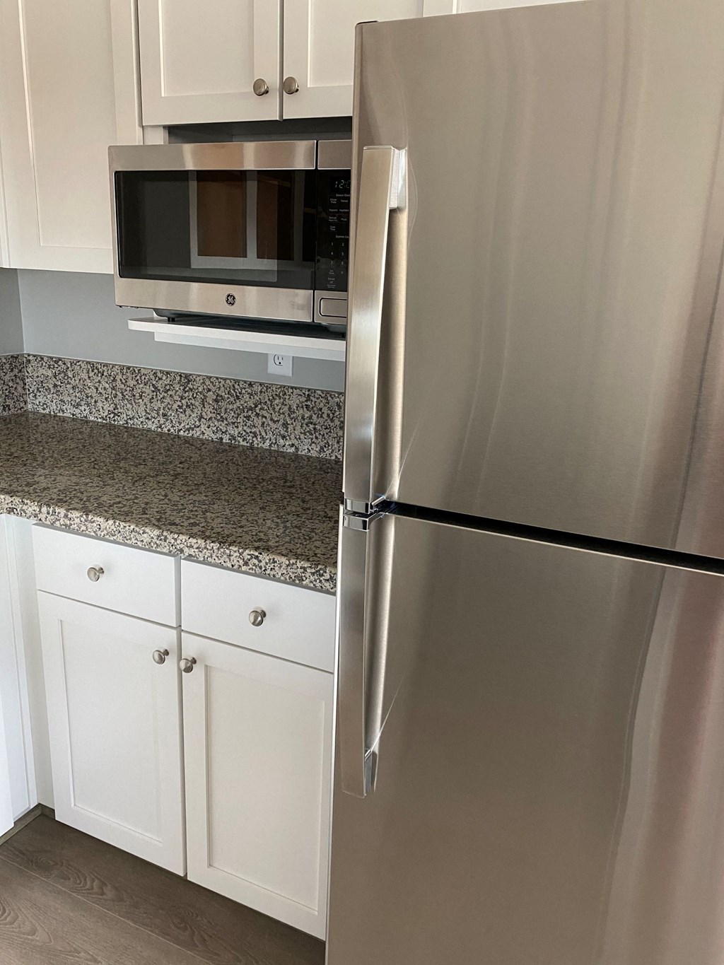 the kitchen has granite counter tops and stainless steel appliances
