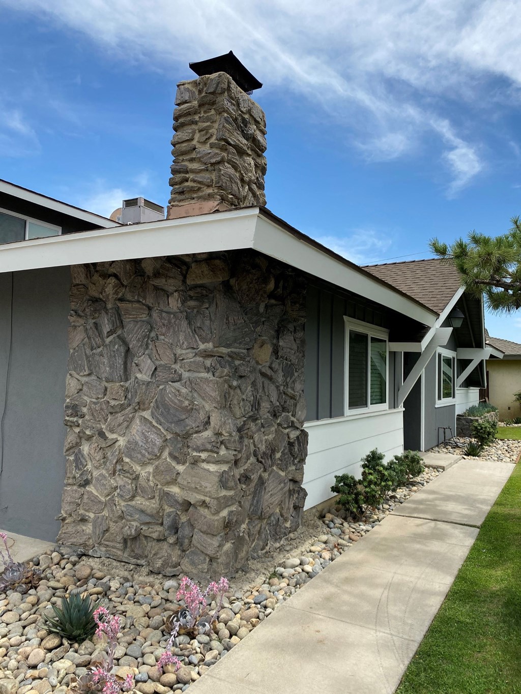 a stone chimney on the side of a house