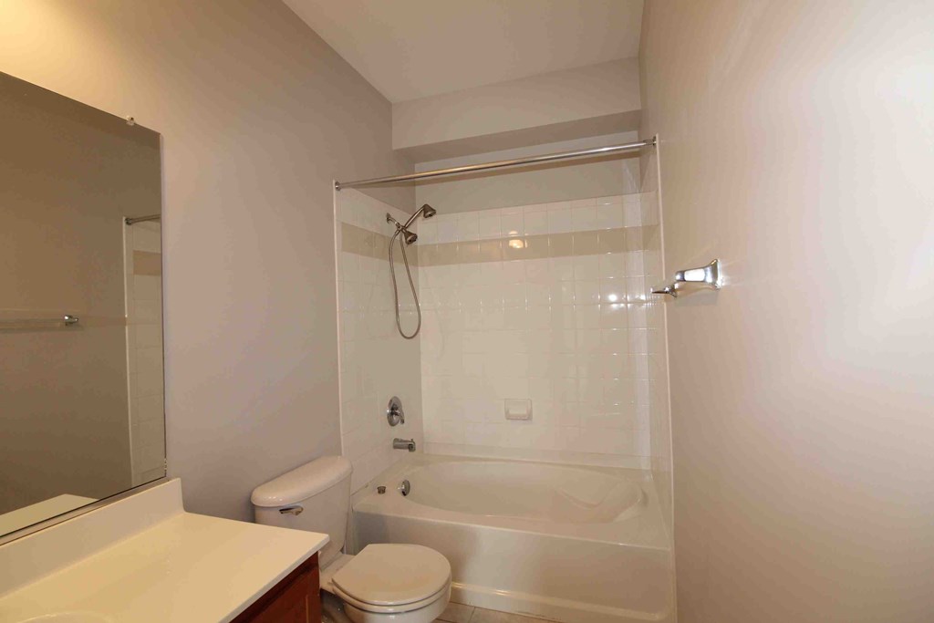 a bathroom with a shower and a toilet and a sink