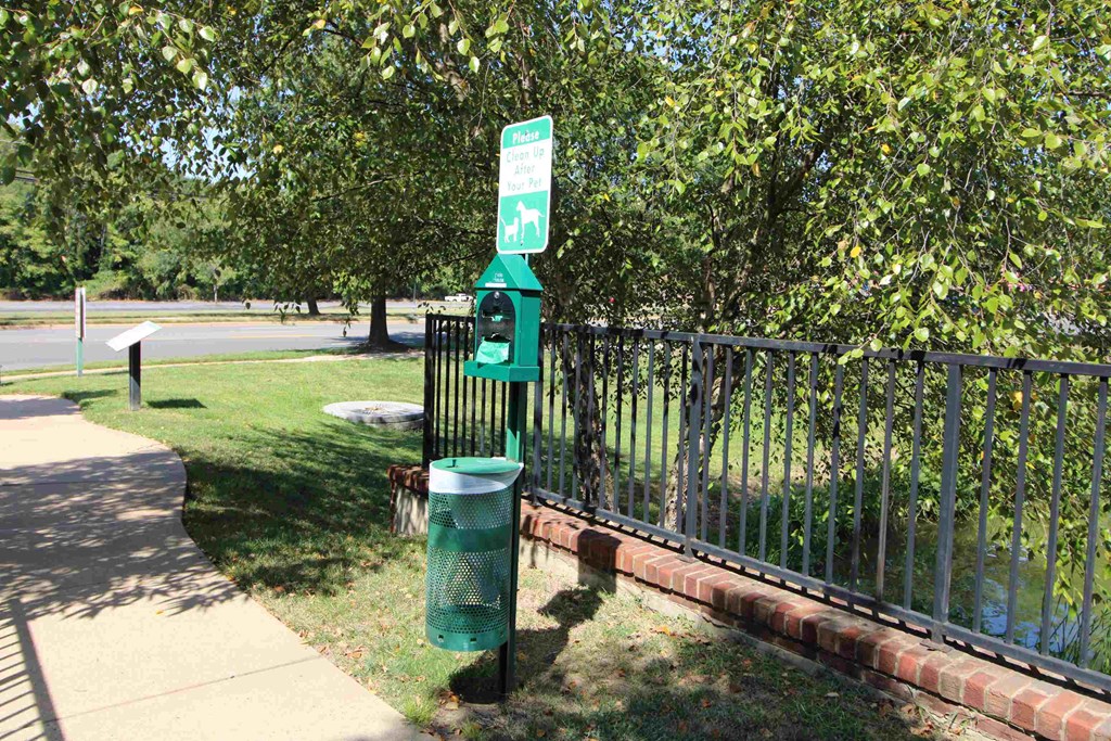 a green parking meter on the side of a sidewalk
