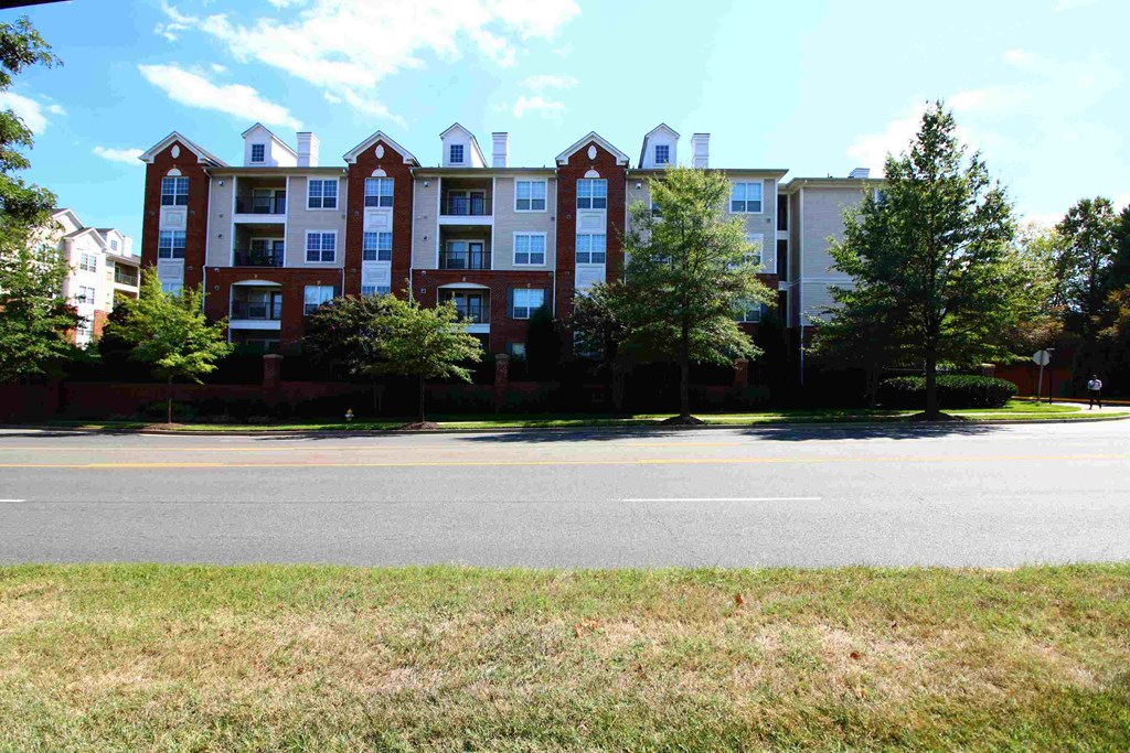 an exterior view of an apartment building on a city street