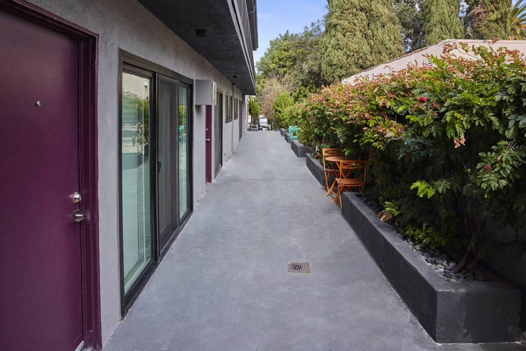 Exterior of unit doors with lush shrubbery