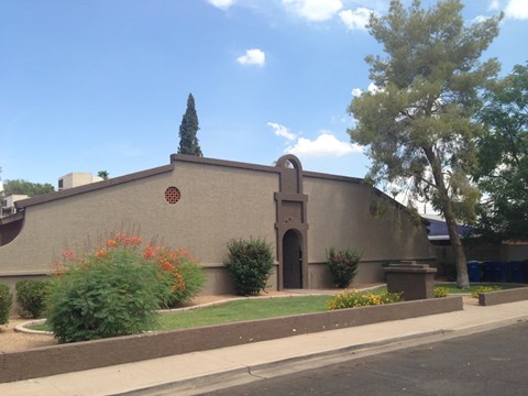 A building with a brown facade and a red circular window.
