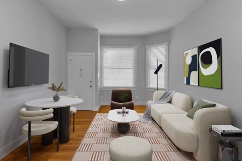 A living room with a white couch, a coffee table, and a painting on the wall.