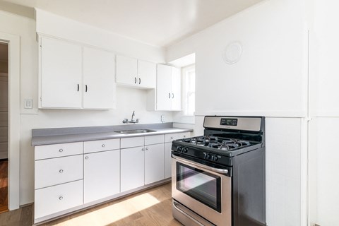 A modern kitchen with a stove and cabinets.