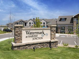 the sign for watermark at harvest junction in front of a building