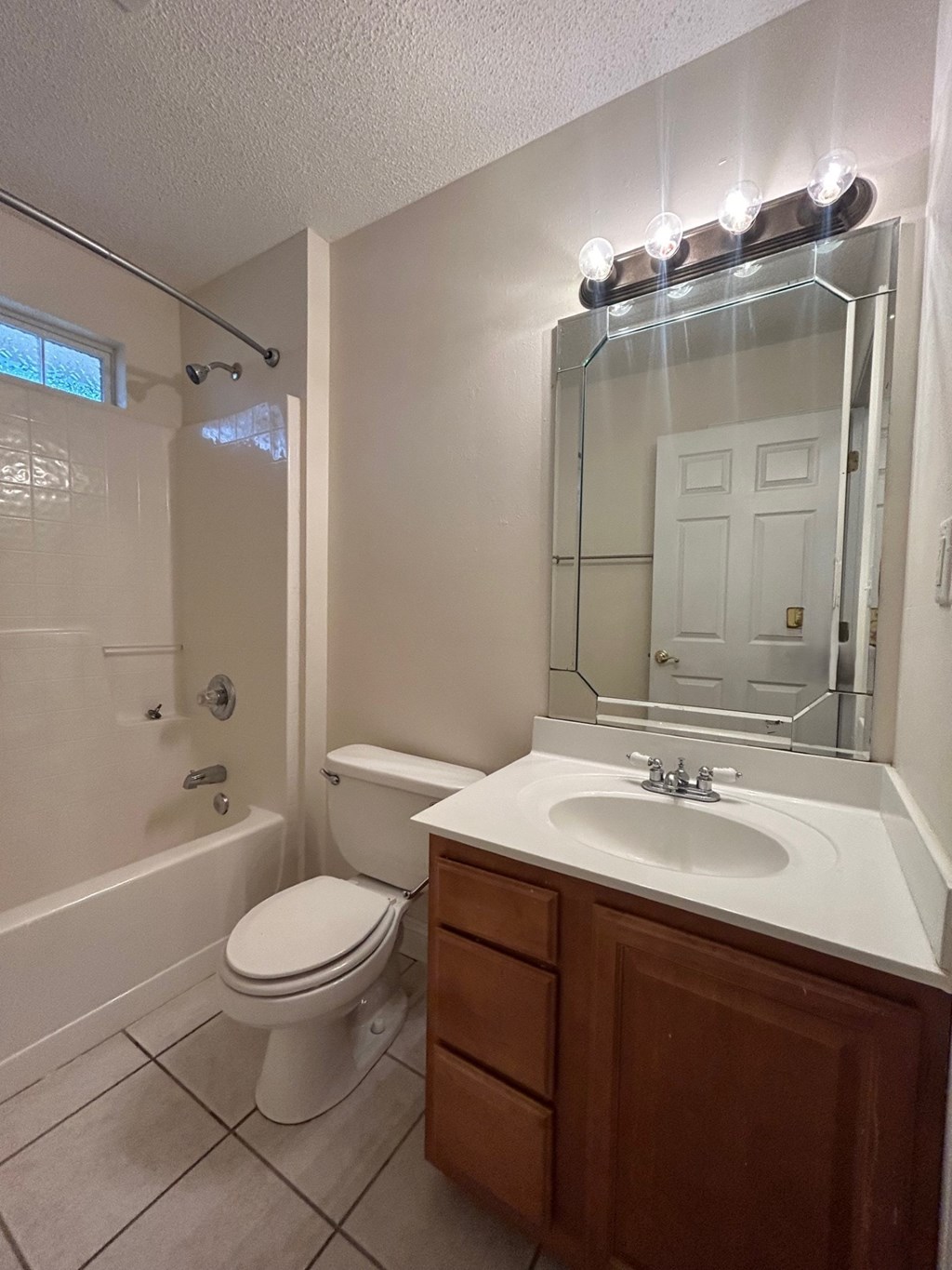 A white toilet sits next to a sink in a bathroom.