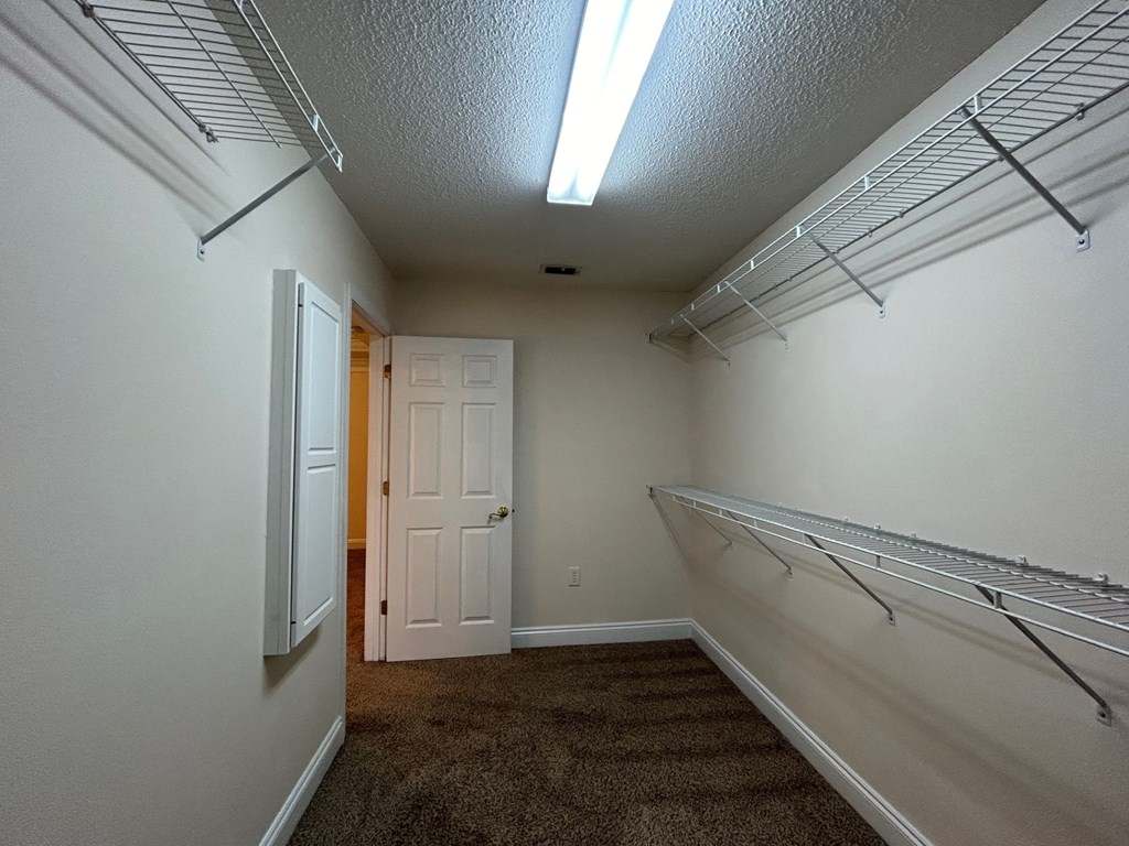 A long hallway with a door at the end.