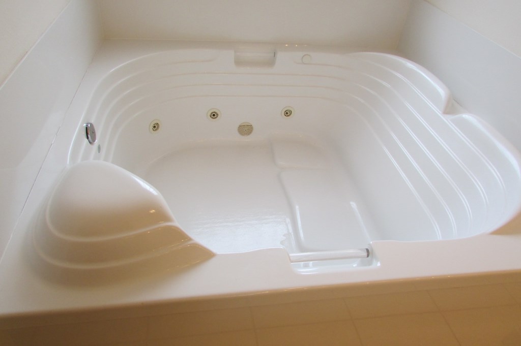 A white plastic container with a lid and a handle.