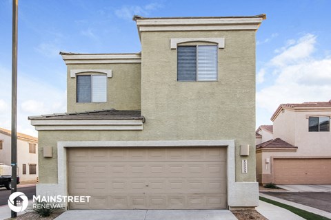 the front of a house with a garage door