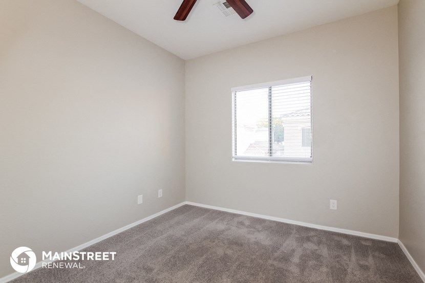 the upstairs bedroom with carpet and a window