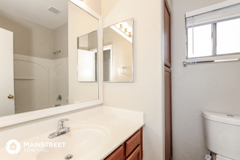 a bathroom with a sink and a mirror and a toilet