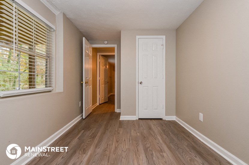 the master bedroom is spacious and has a door to the hallway