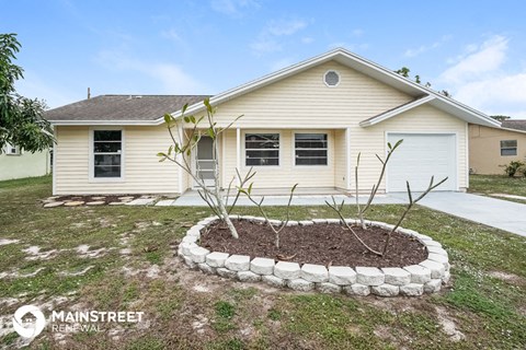 a front yard with a garden and a house